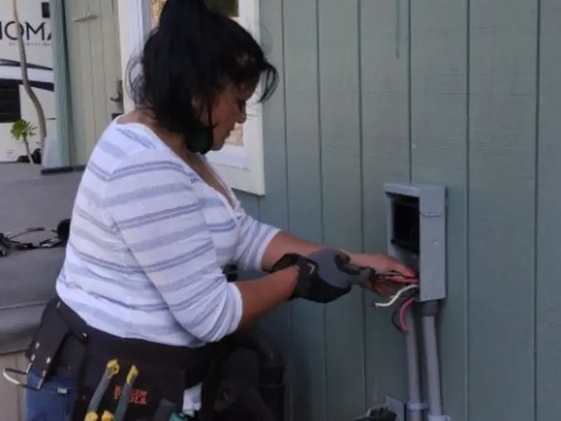 Licensed electrician wiring an exterior subpanel in Sunset Beach